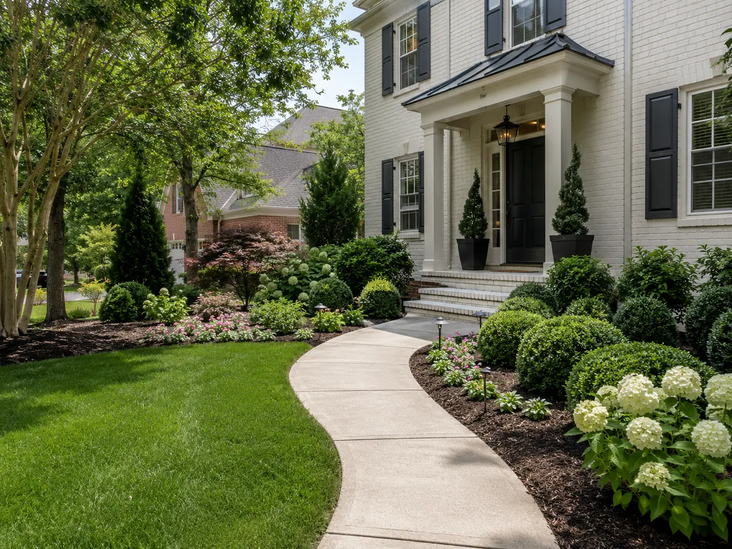 Front yard landscaping improvements in Charlotte NC with walkway, lawn, shrubs, and residential planting beds