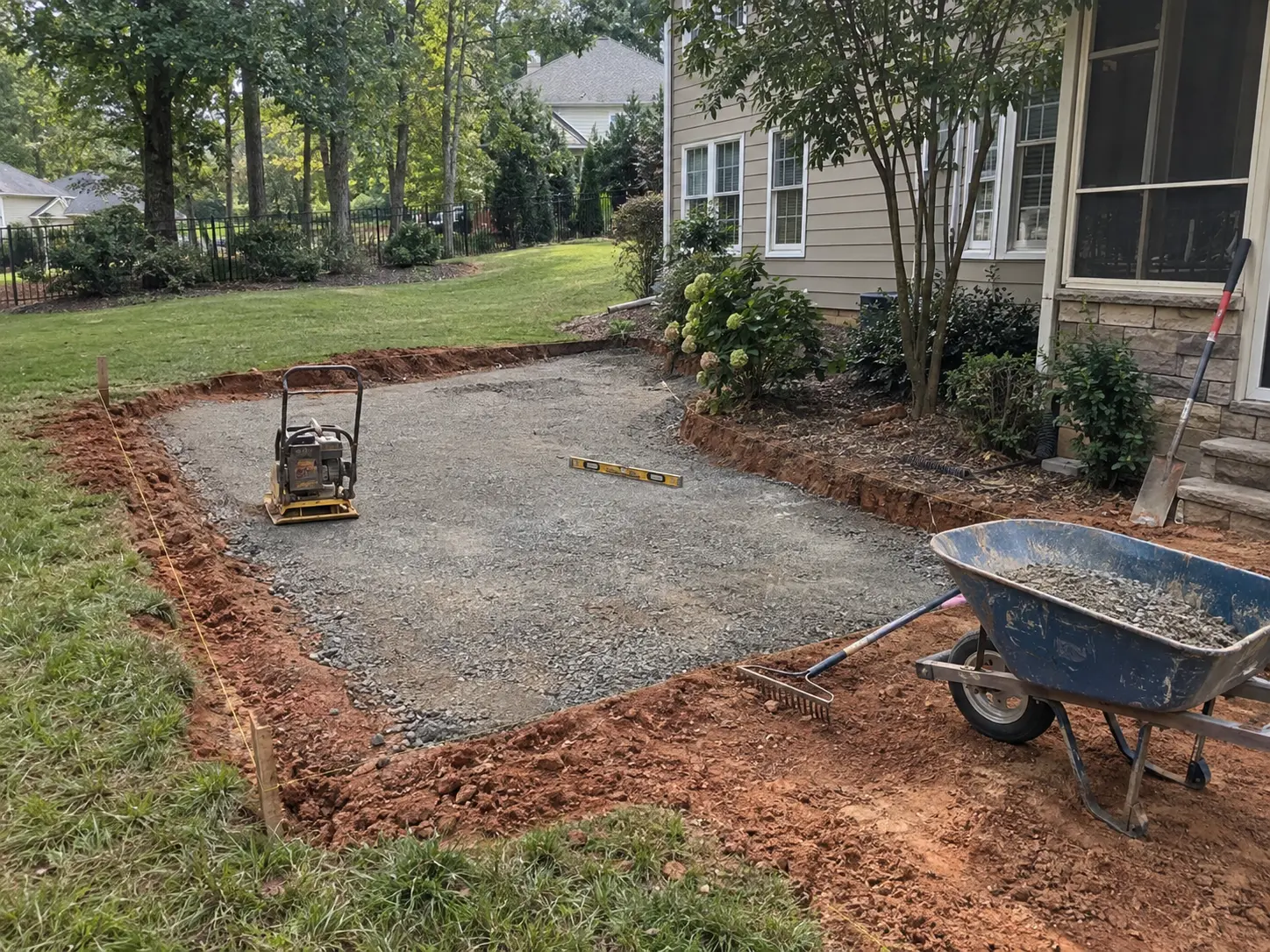 Hardscape site preparation with clay soil, grading and drainage conditions in Charlotte